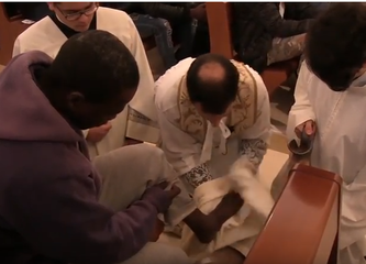 Trani religiosa, il parroco di Santa Chiara lava i piedi agli immigrati. Foto e video dei riti del Giovedì santo